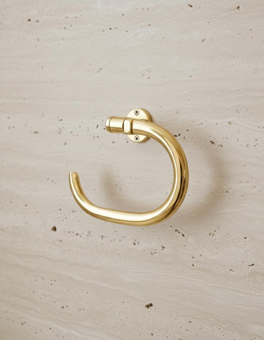 Gold door handle on a beige wooden surface