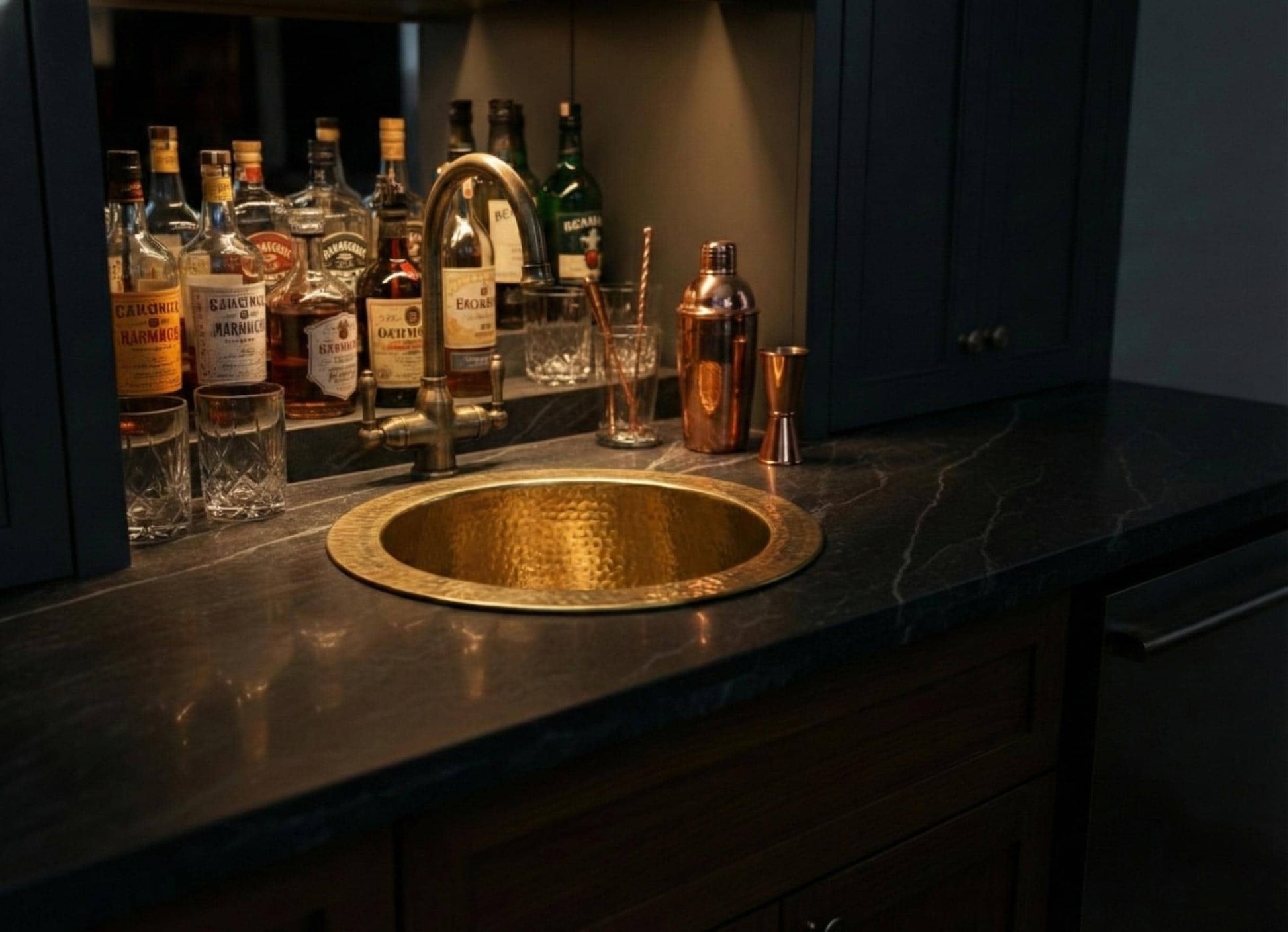 Bar setup with bottles and a gold sink in a dimly lit room
