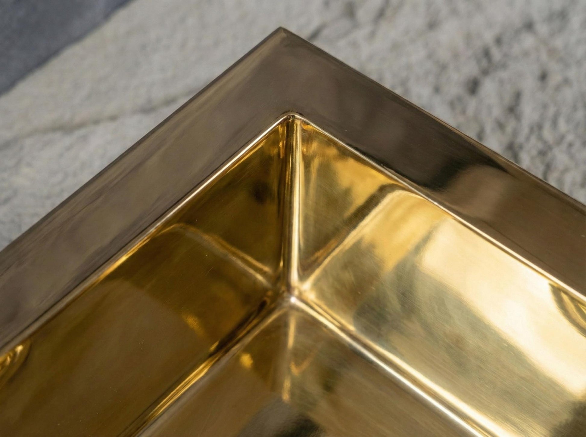 Close-up of a gold corner structure on a textured surface