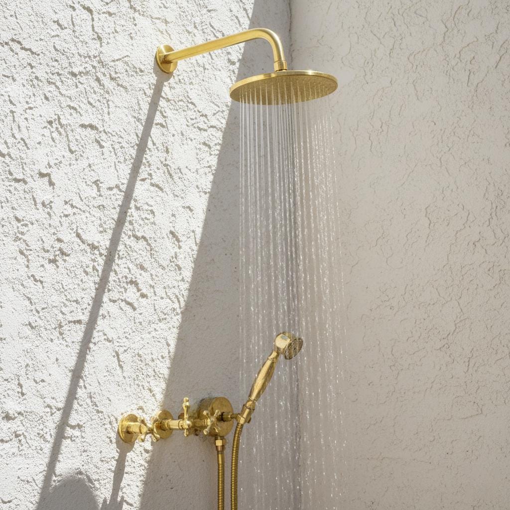 Gold shower head and fixtures on a textured wall