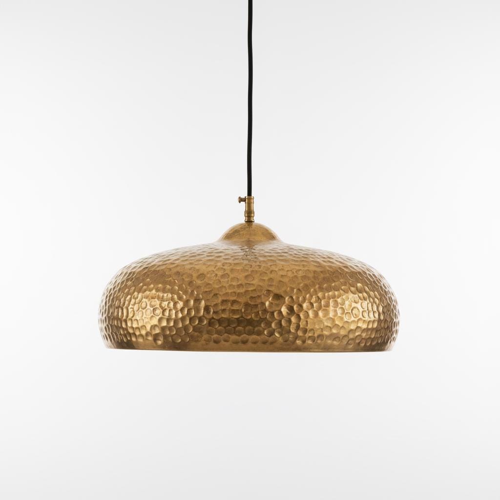 Gold pendant lamp with a textured surface on a white background