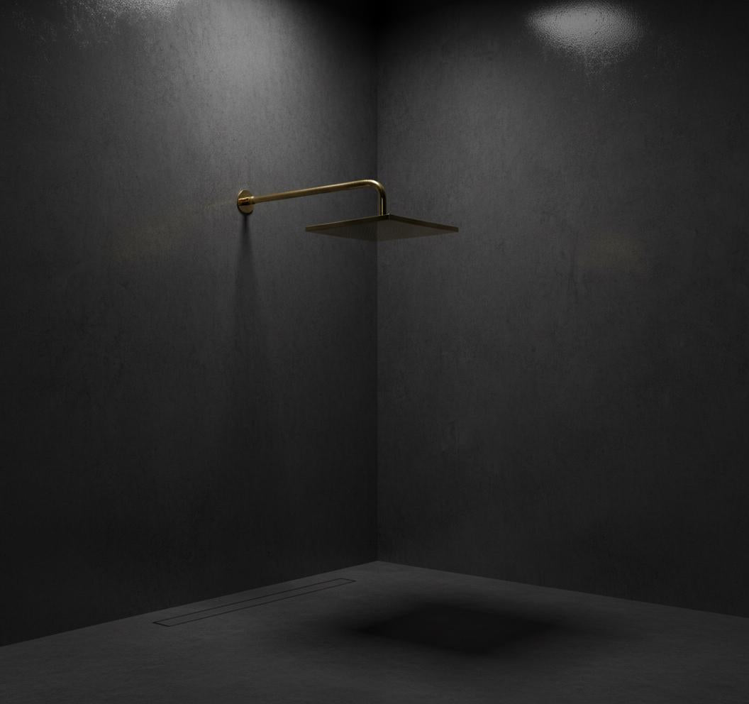 Gold shower head mounted on a dark wall