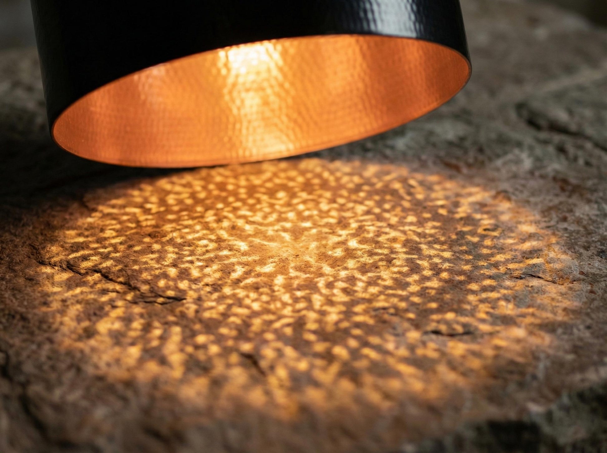 Close-up of a light source casting a warm glow on a textured surface