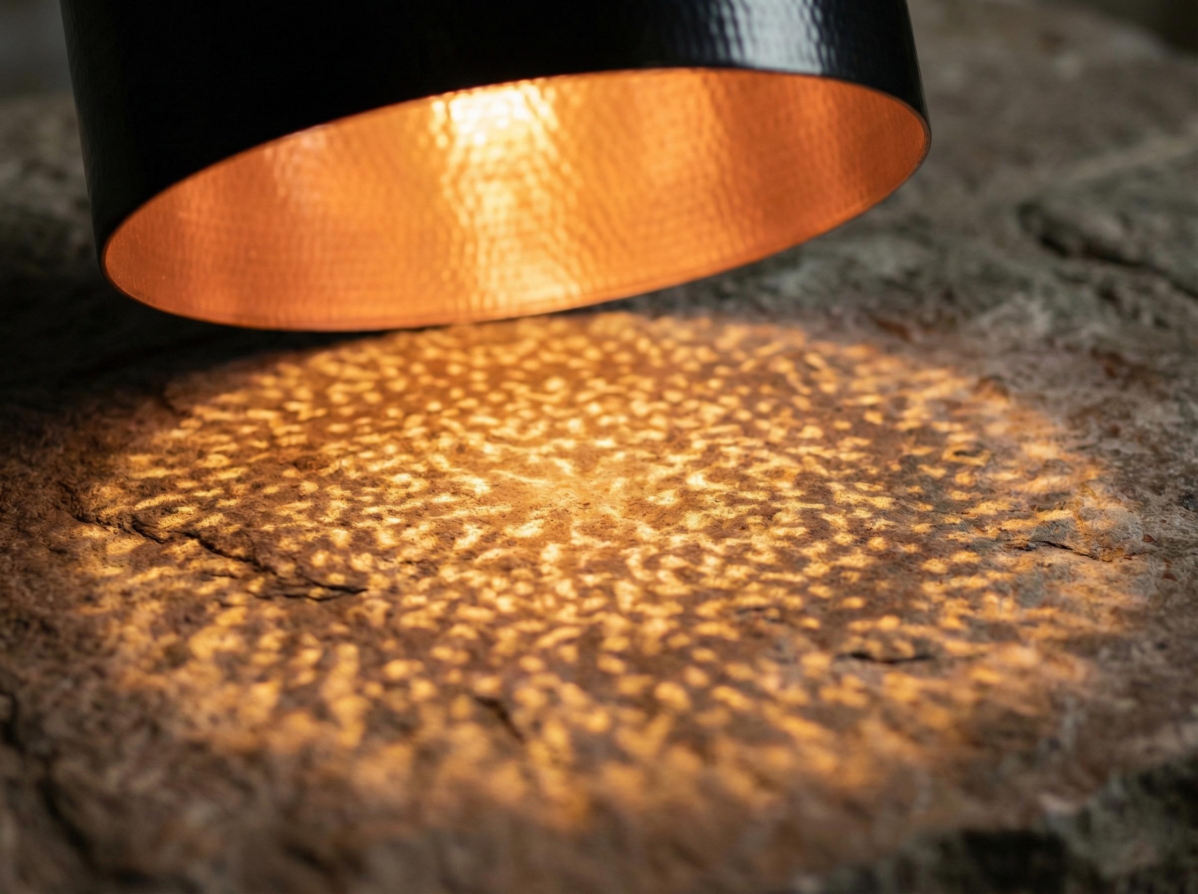 Close-up of a light source casting a warm glow on a textured surface