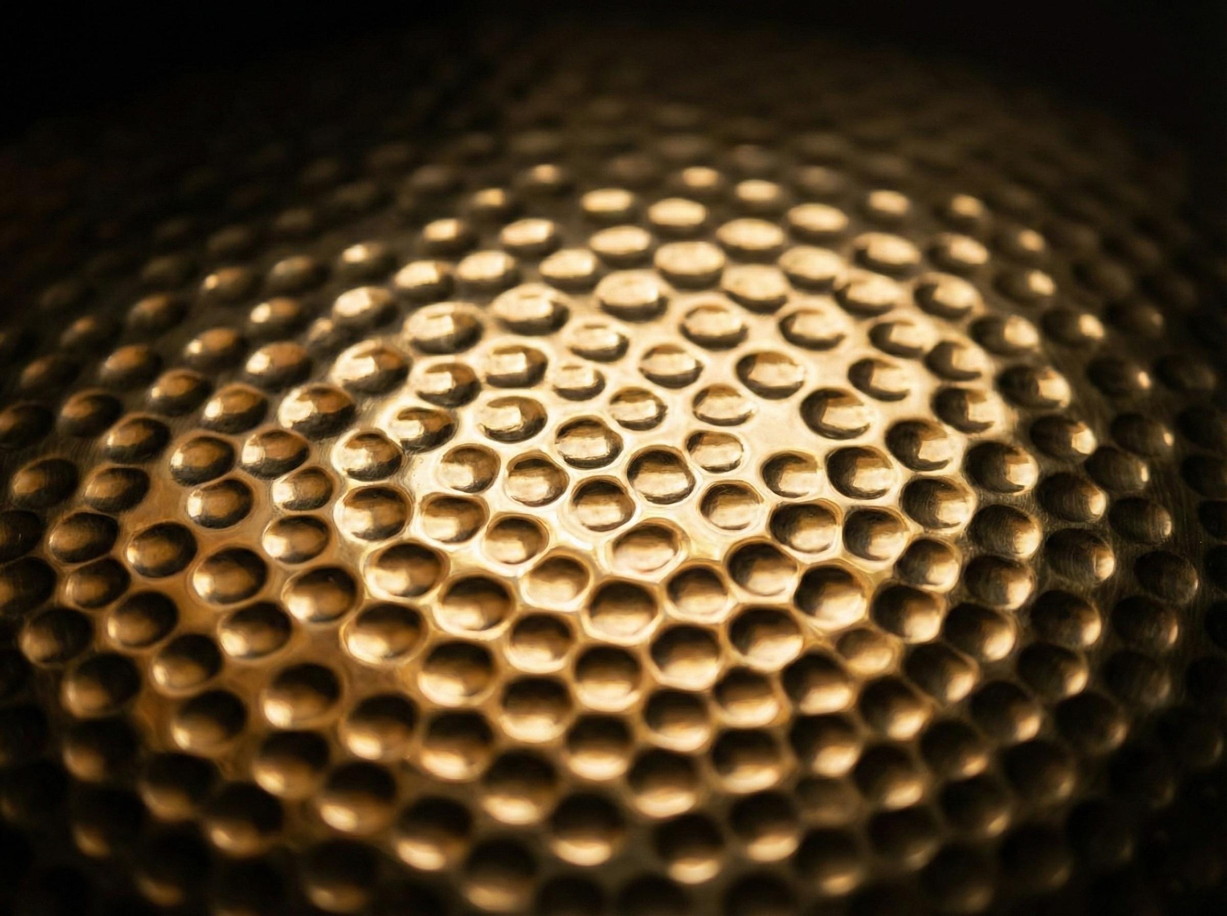 Close-up of a textured gold surface with circular patterns