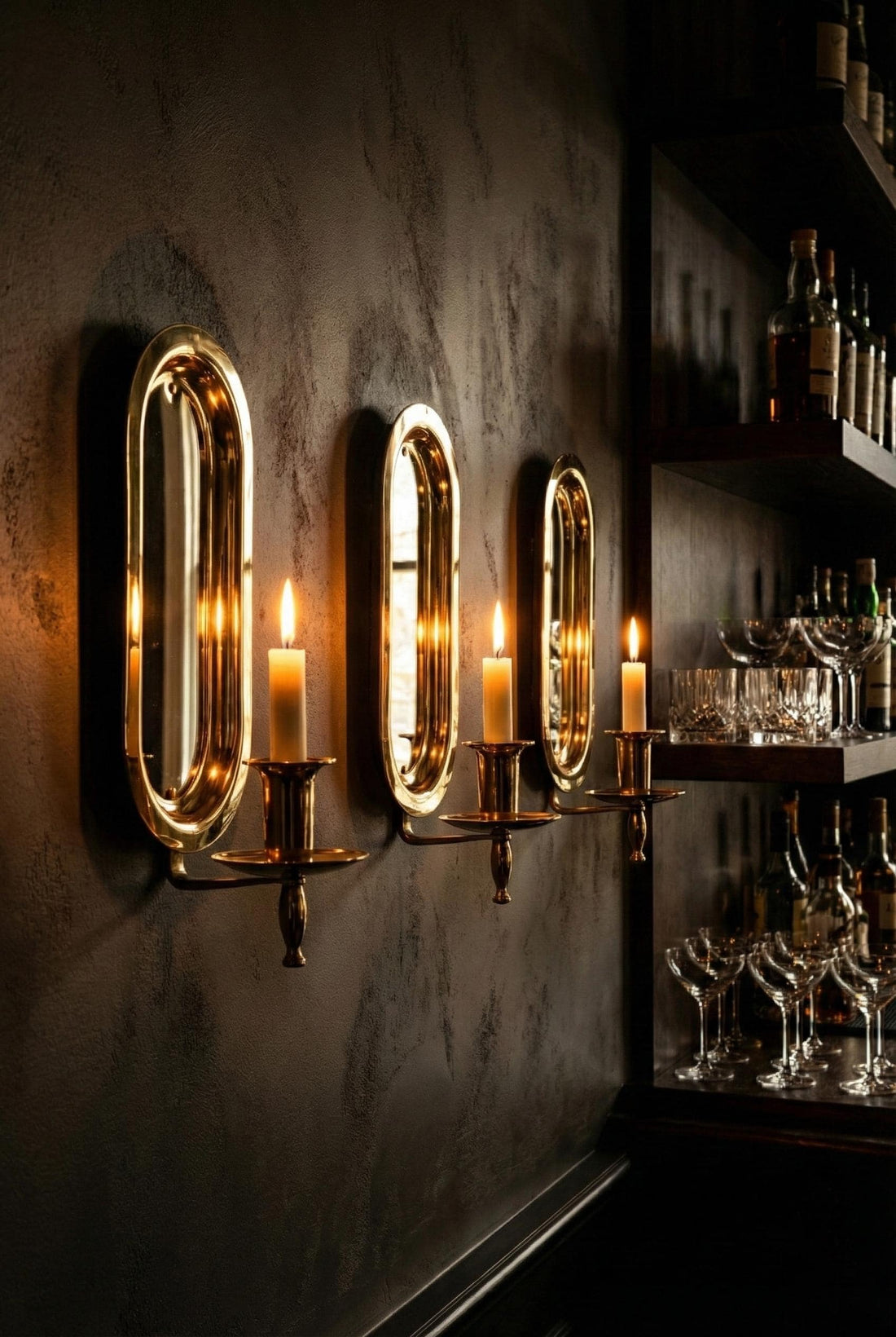 Decorative wall sconces with candles on a wall with intricate pattern