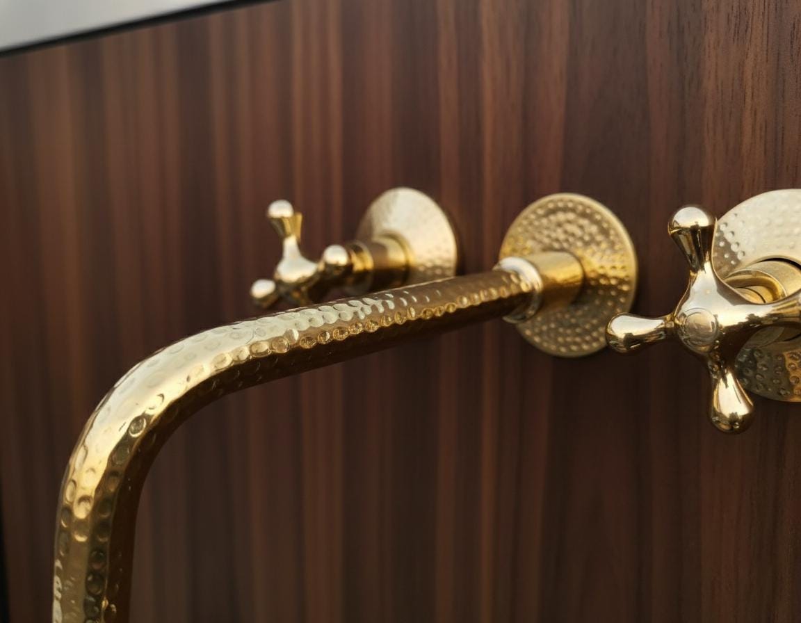 Close-up of a gold faucet on a wooden background