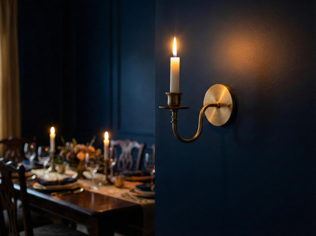Candle in a brass wall sconce on a marble fireplace