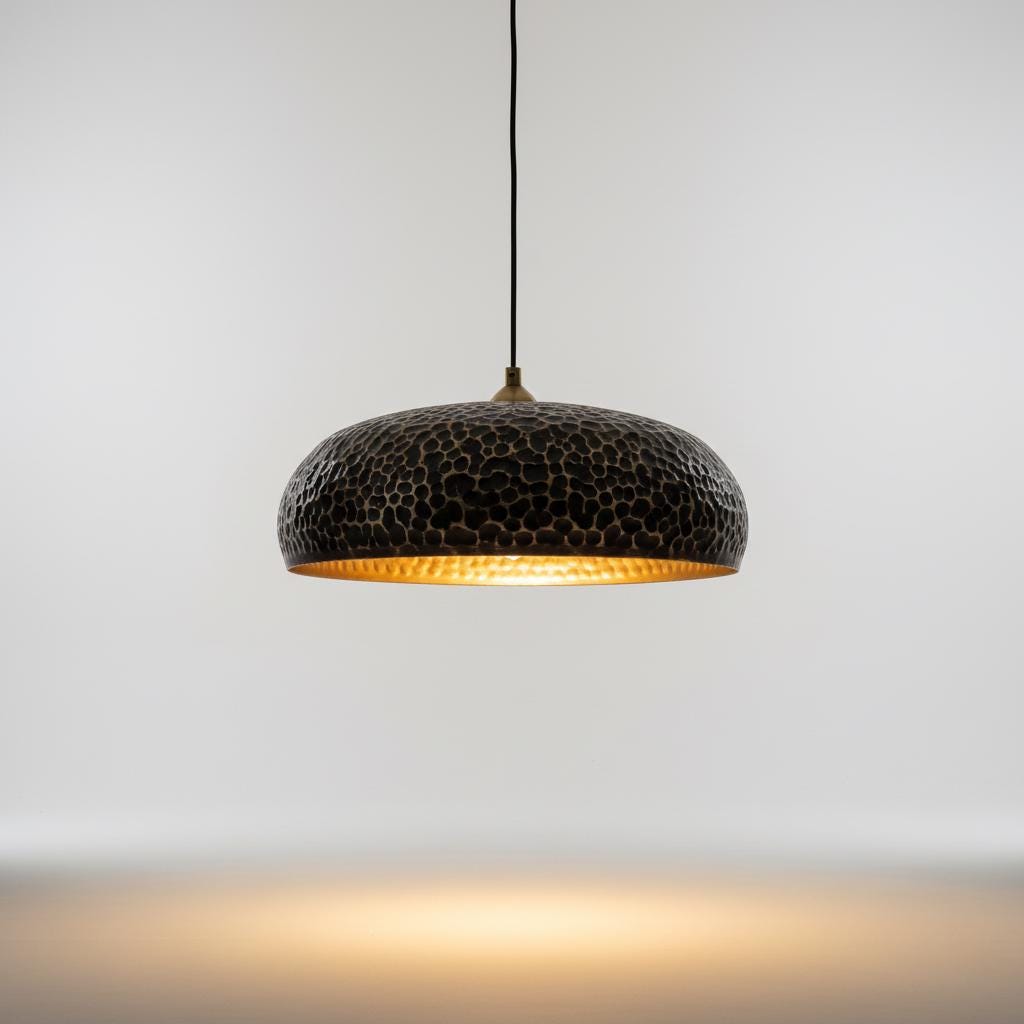 Black textured pendant light against a neutral background