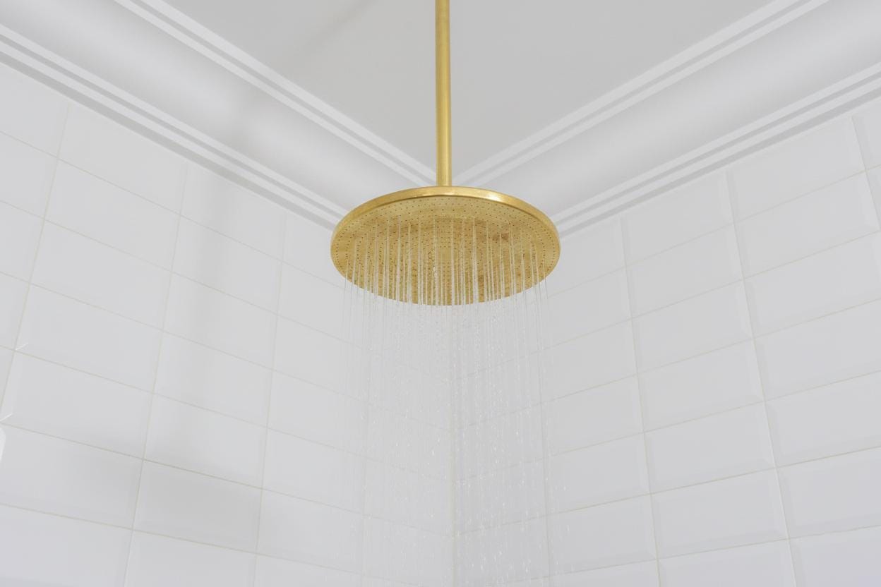Gold pendant light fixture on a white ceiling
