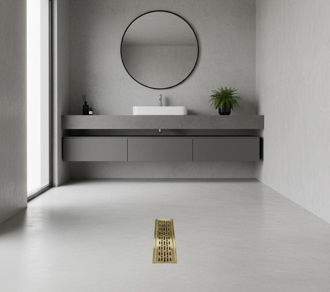 Modern bathroom with a floating vanity and round mirror, featuring a gold floor drain.