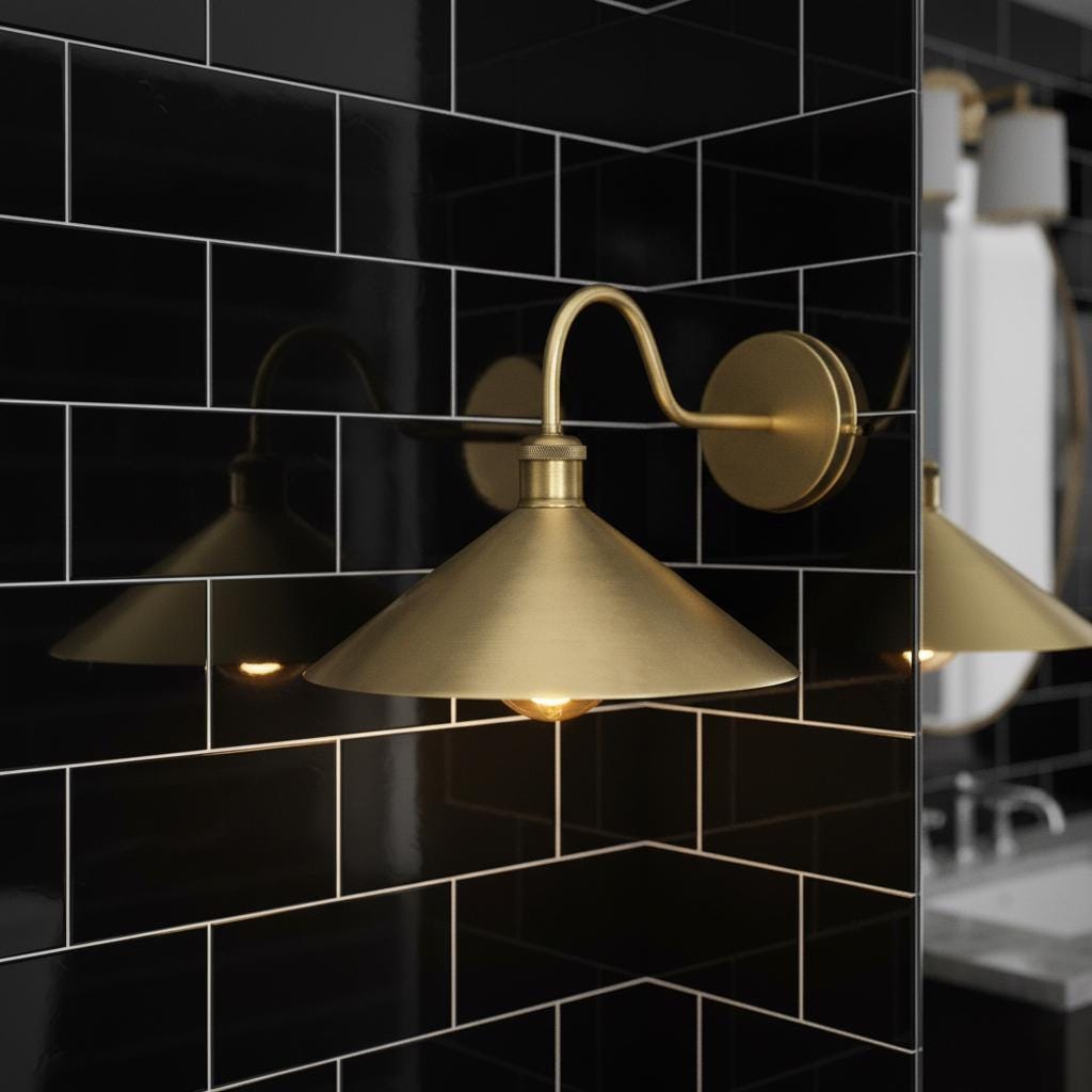 Gold wall-mounted lamp against a black tiled wall