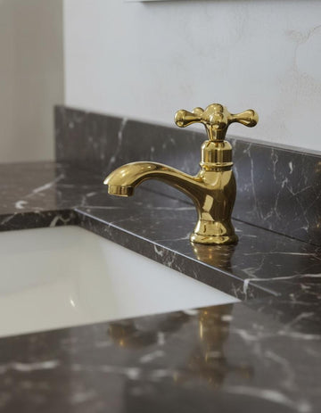 Gold faucet on a marble countertop