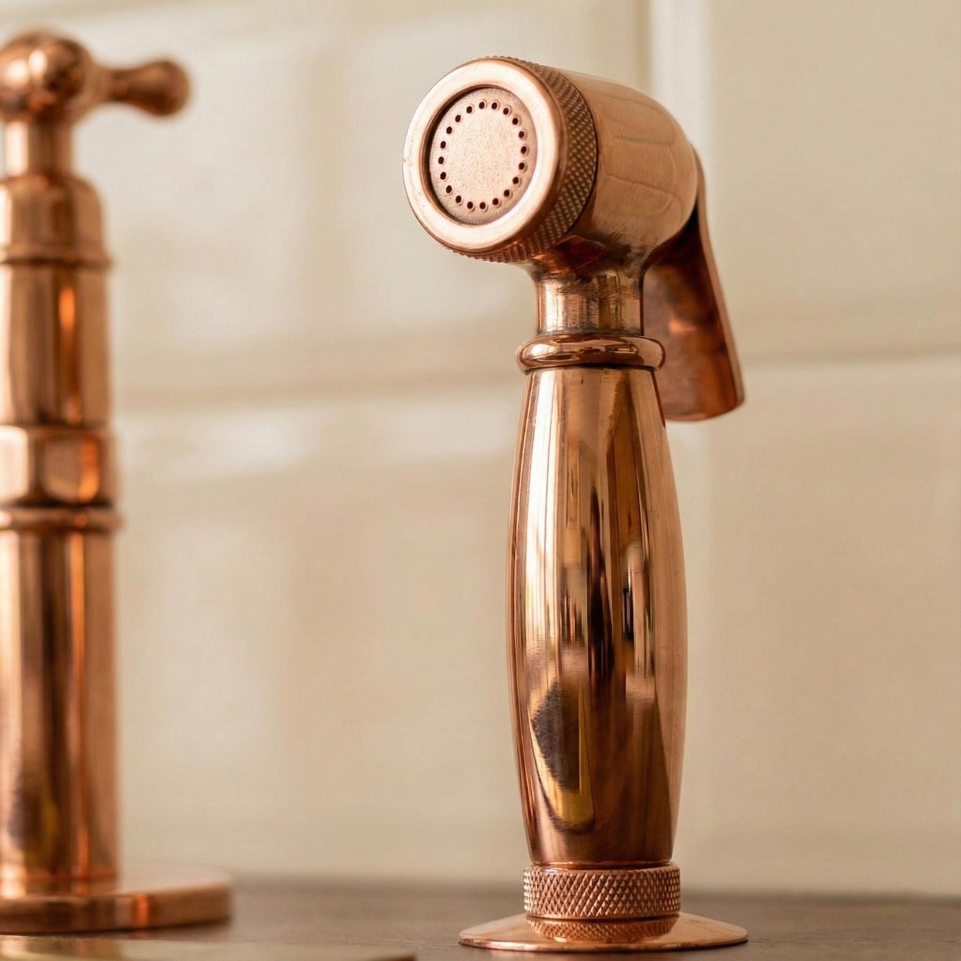 Copper shower head and faucet on a neutral background