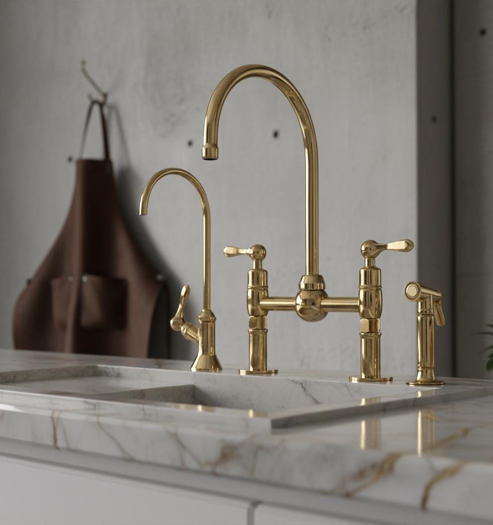 Gold kitchen faucet set on a marble countertop with a neutral background