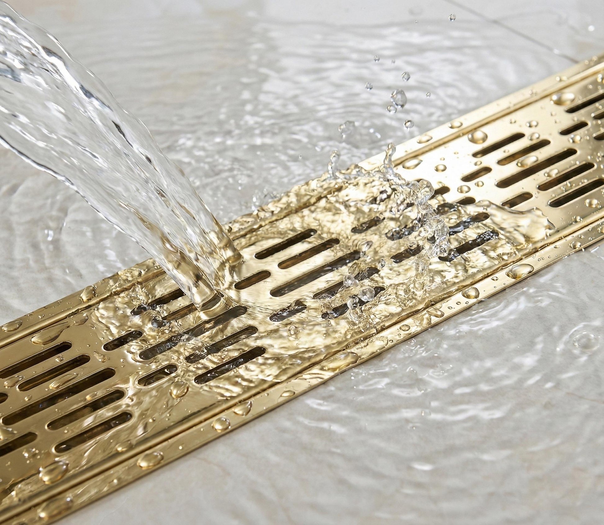 Gold shower drain with water flowing into it on a tiled bathroom floor.