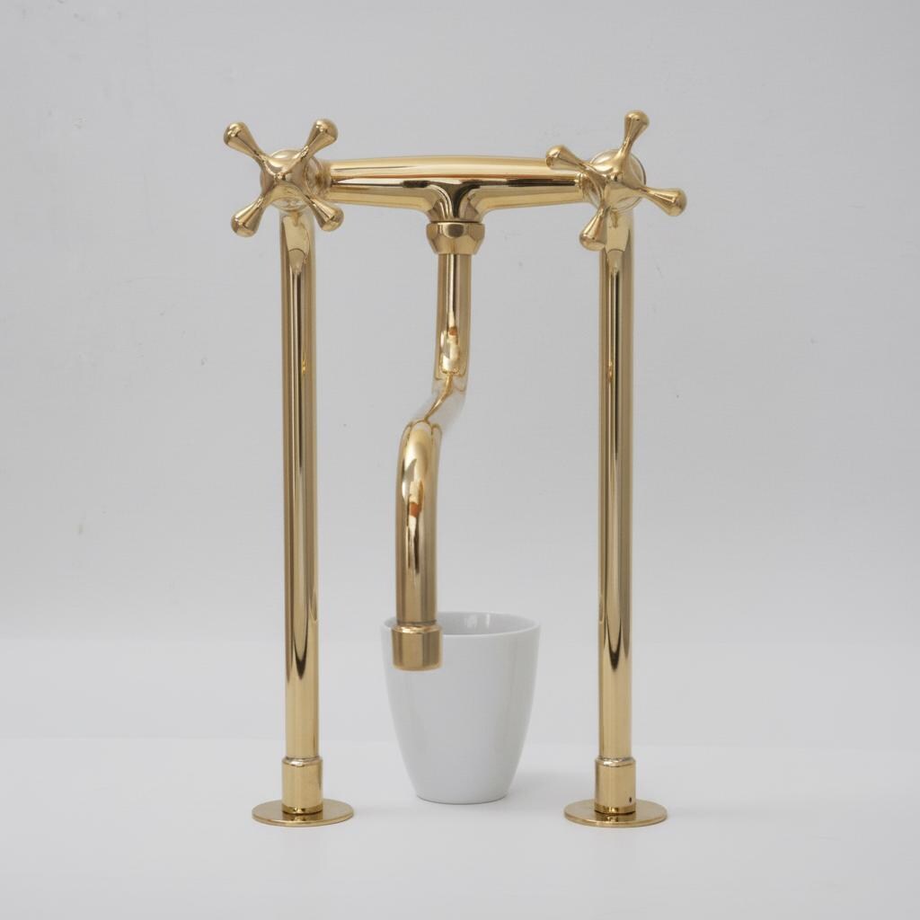 Gold faucet with a white cup on a gray background