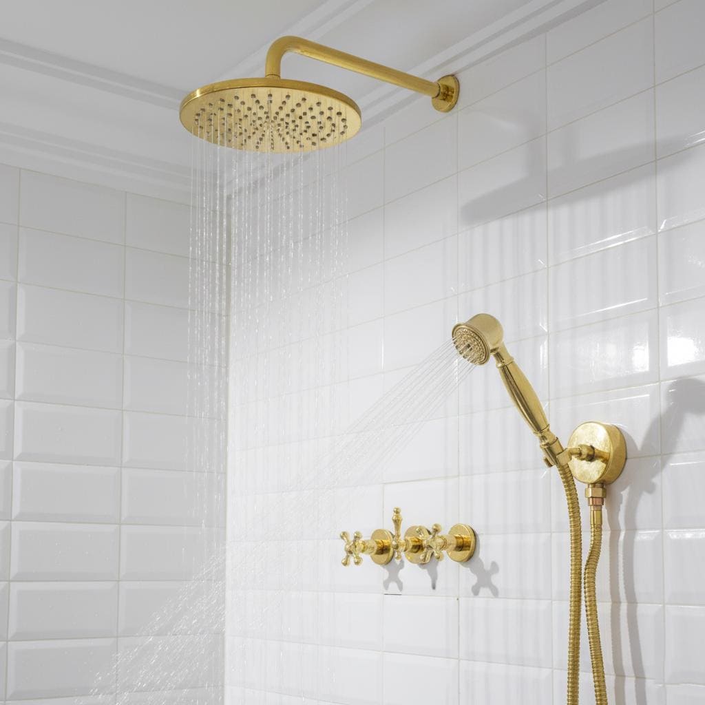 Gold shower head and handheld shower on a white tiled wall