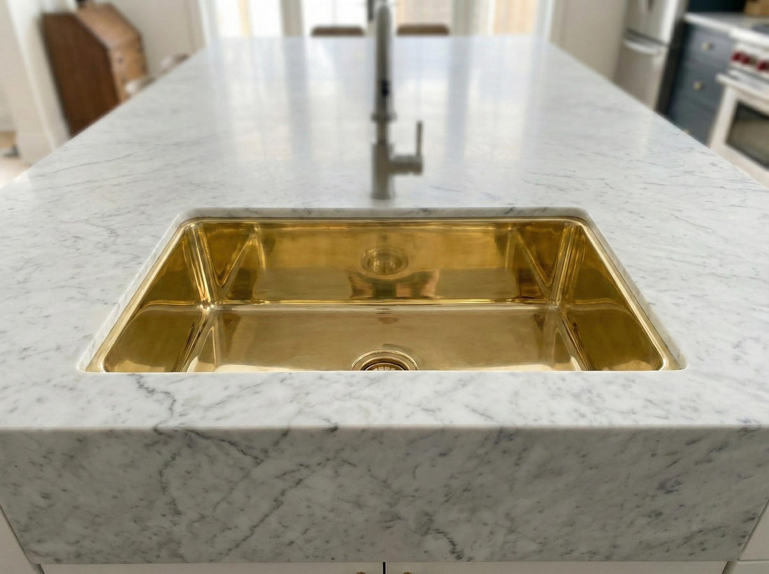 Gold sink with running water in a modern kitchen setting