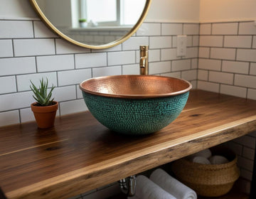 Bathroom vanity with a copper and green mosaic sink, wooden countertop, and tiled wall.