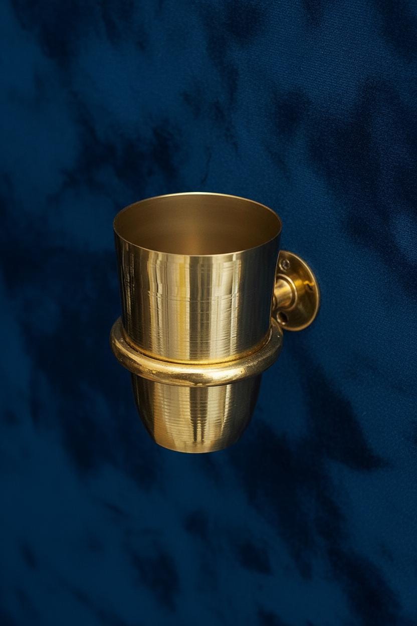 Gold cup with handle on a blue textured background