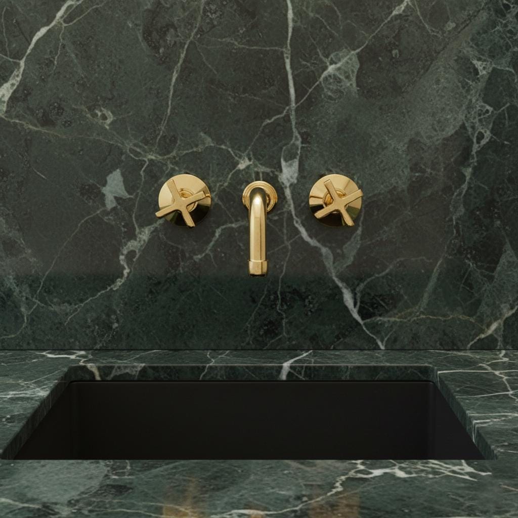 Gold faucet and handles on a dark marble sink