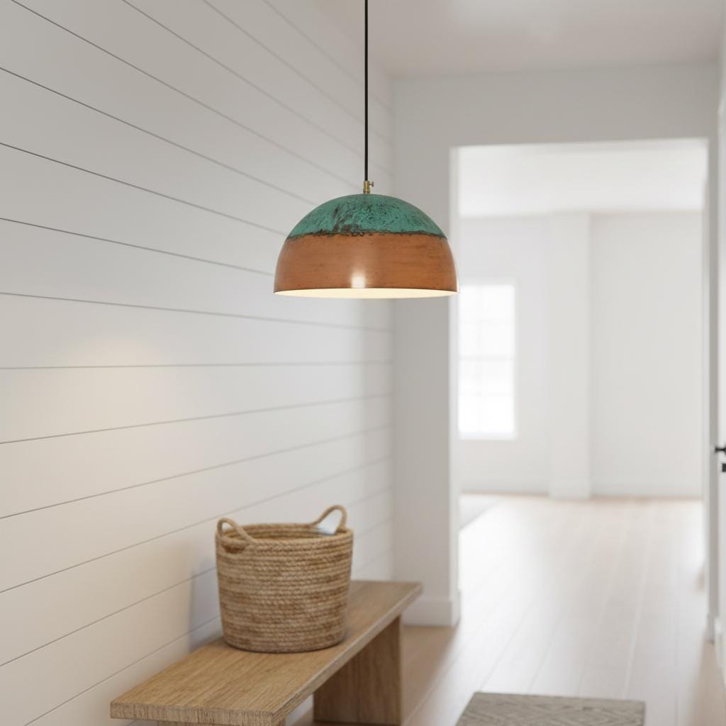 Pendant light with wooden shade and green interior in a room with white walls and a wooden bench.