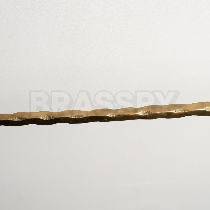 Golden brass kitchen rail rack with patina forming on surface

