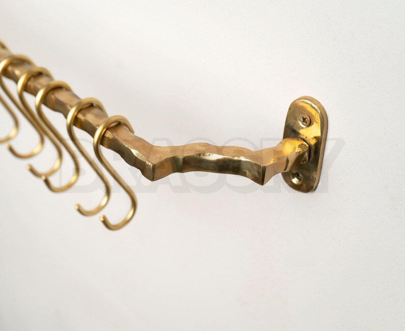 Golden brass kitchen rail rack with patina forming on surface

